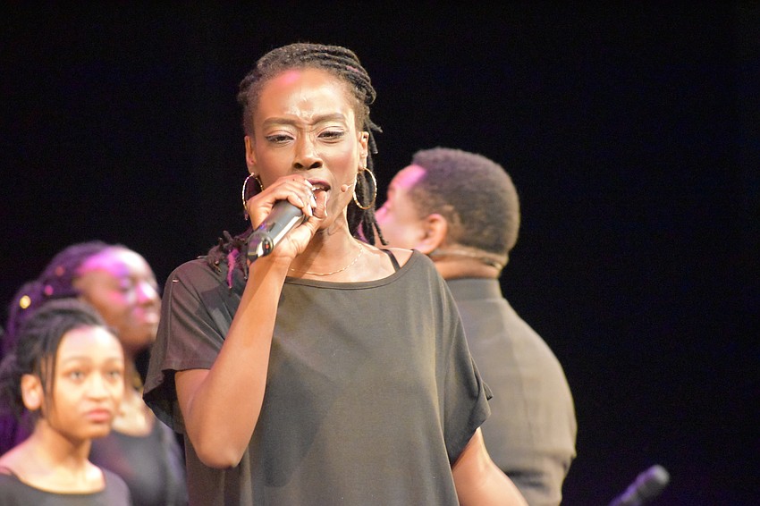 Ashley D. Brooks, a featured soloist, sings at the event.