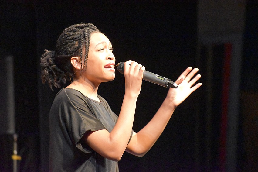Maicy Powell sings during the performance.