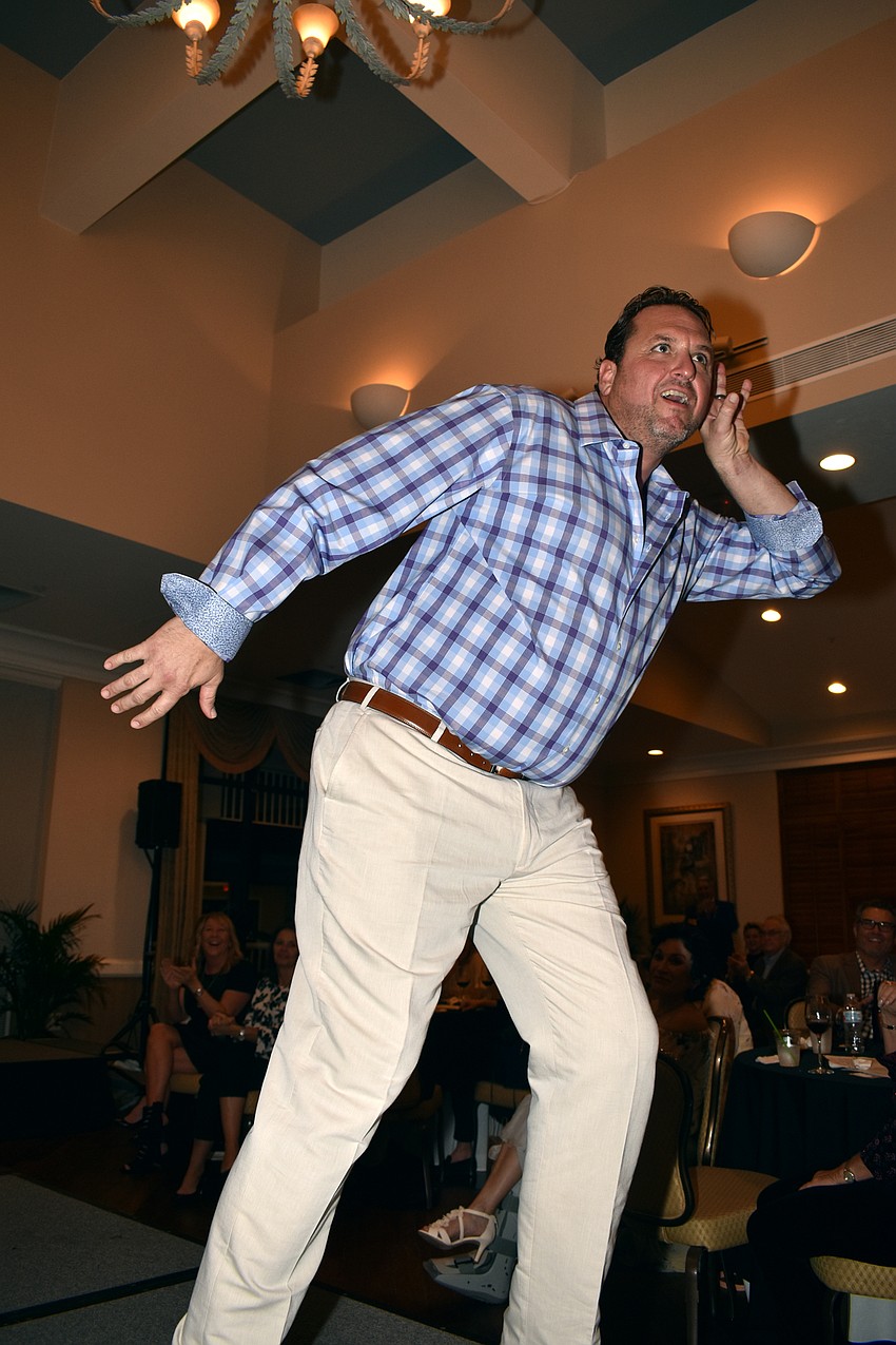 Hal Christensen makes the crowd laugh as he walks the runway.