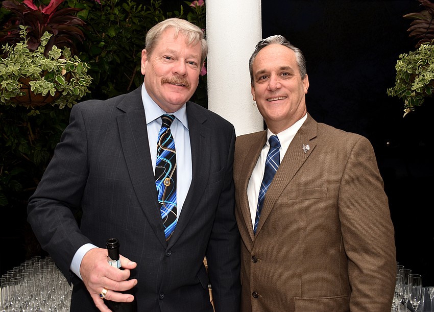 “Local Heroes” bartenders Longboat Key Police Chief Pete Cumming and Fire Chief Paul Dezzi