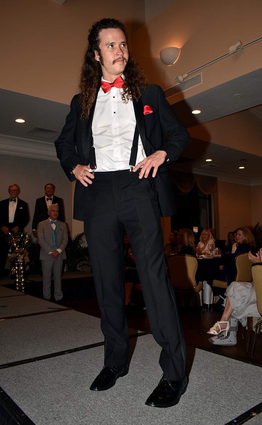 Jay McWilliams gives the crowd a look as he models a suit from Men’s Wearhouse.