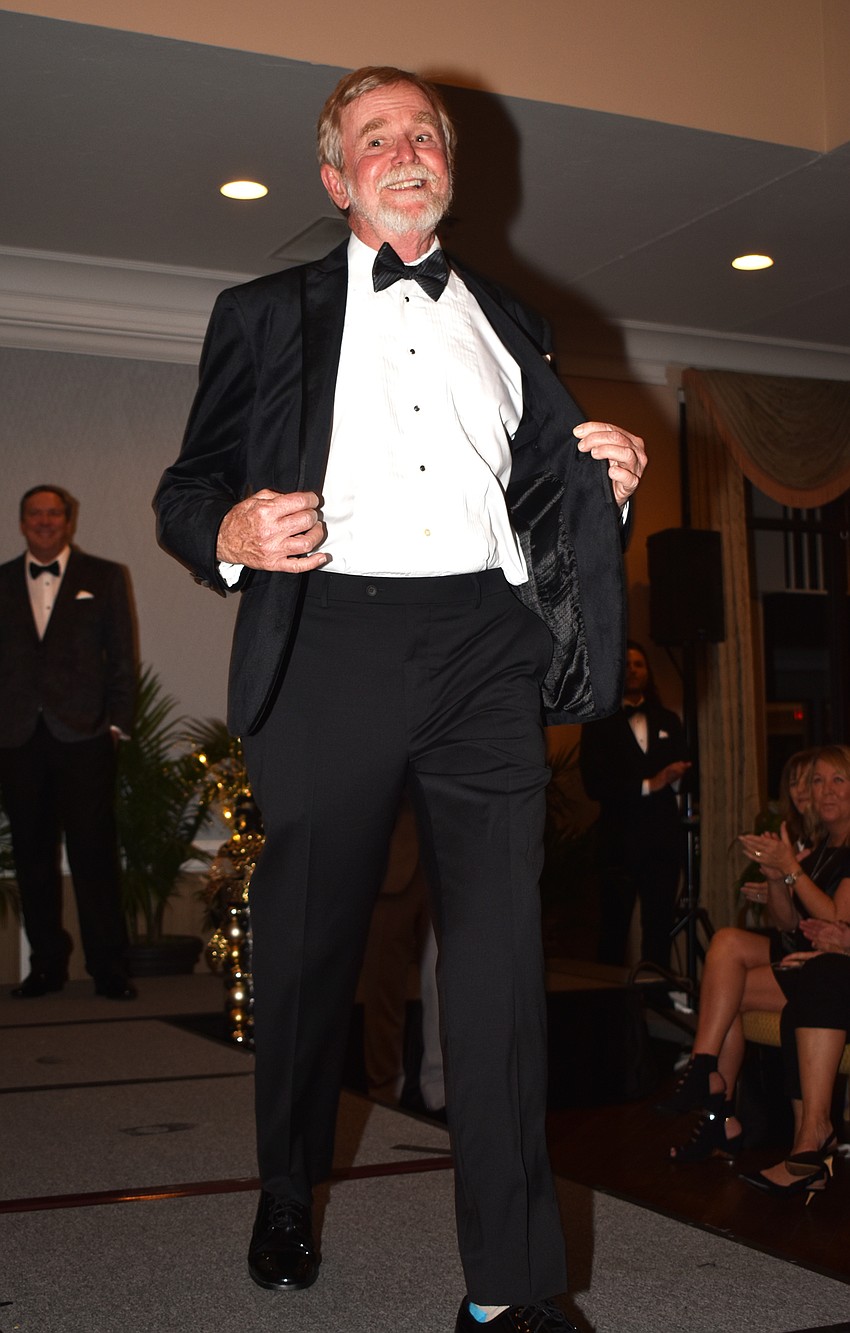 Rusty Chinnis shows off a tuxedo from Men’s Wearhouse.