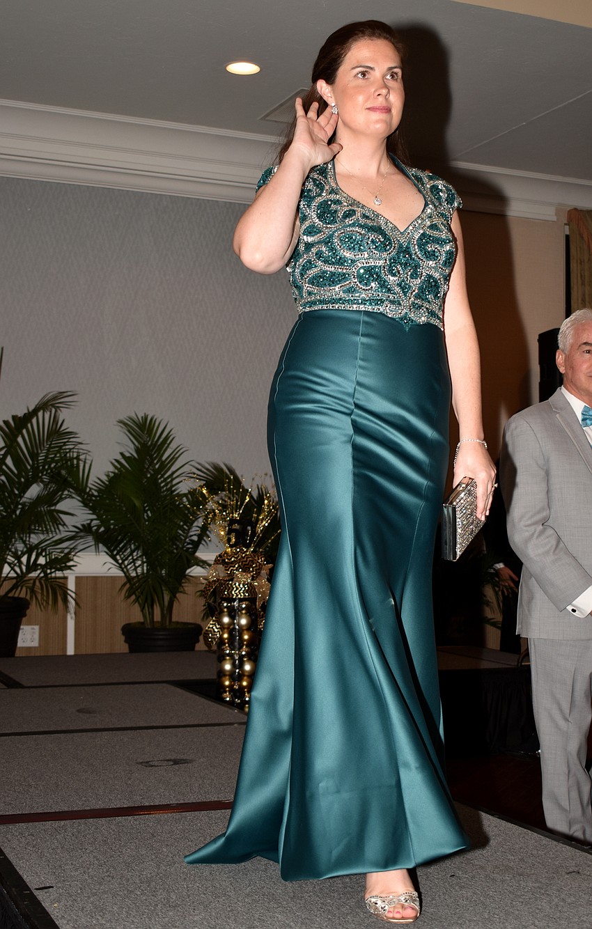 Siobhan Young points to the earrings she is modeling.