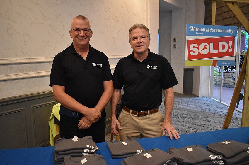 Pierre Dagenais and Craig Ervin help hand out t-shirts to event goers.