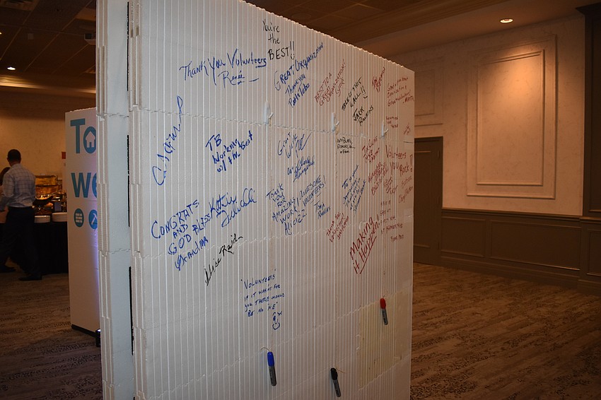 Guests were invited to sign this wall, which will be built into a house for a family.