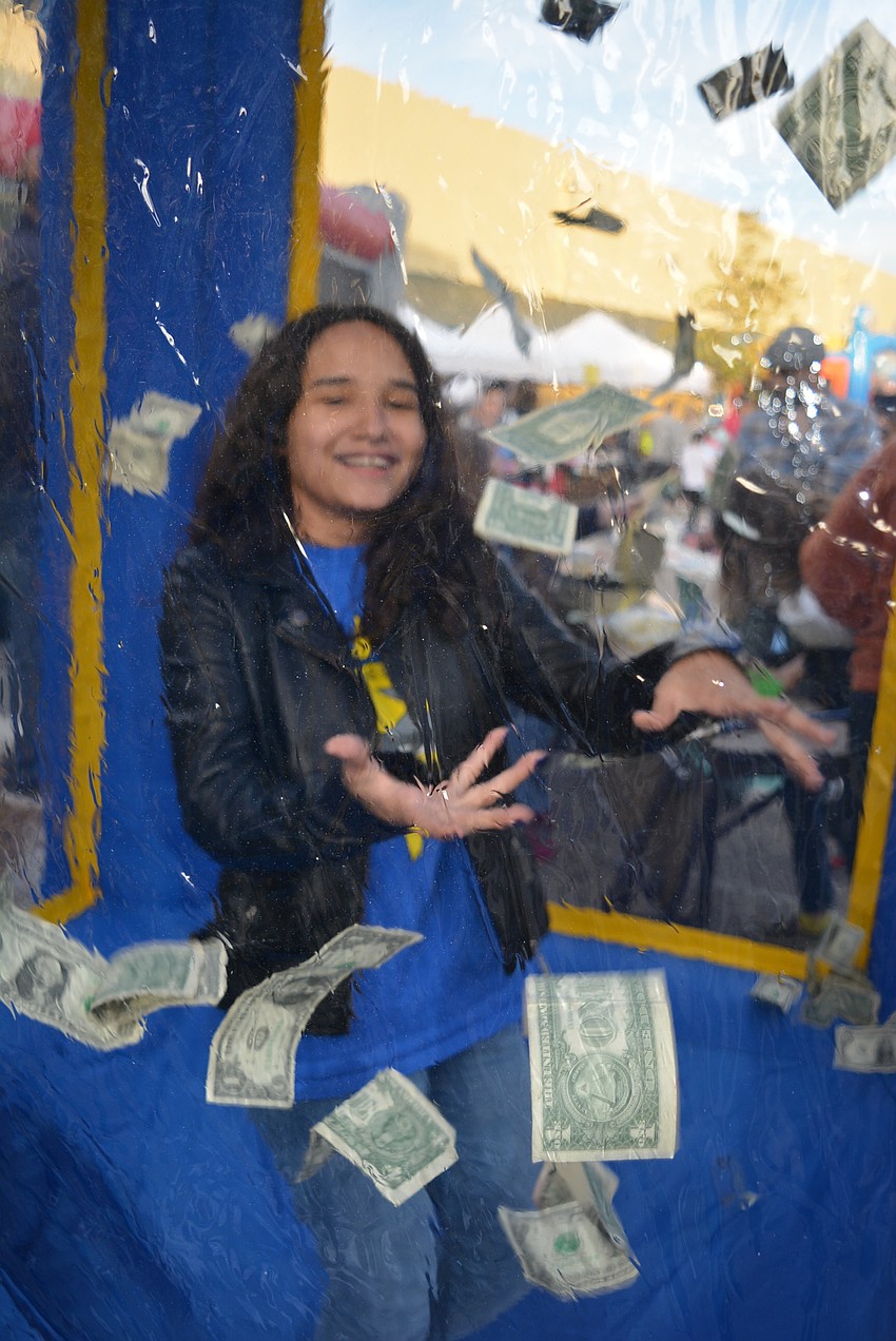 Seventh-grader Micaela Castro demonstrates catching money in the 