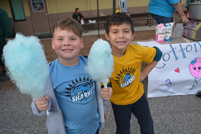 Parrish's Landon Turnbull and Ellenton's Augusto Strubbe are in the same first grade class. They were excited about their blue raspberry cotton candy.