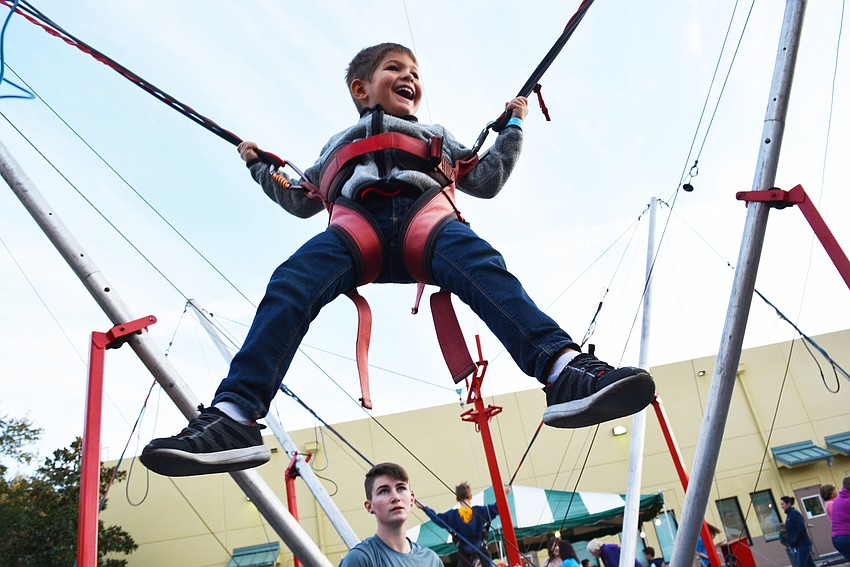 Four-year-old Danny Lawson cannot wipe the smile off his face as he bounces through the air. 