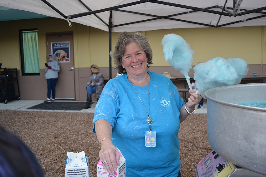 Third-grade teacher Kathy Hughes has to smile about how covered with cotton candy she is.