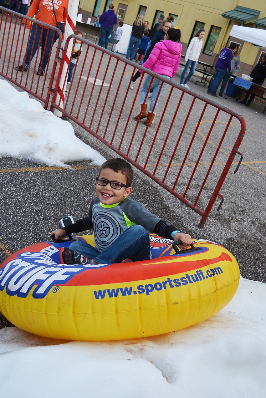 Four-year-old A.J. Lopez, of Ellenton, likes going fast down the slide.