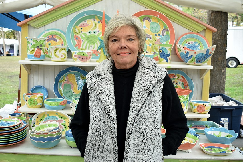 Susan Painter poses with her pottery collection.