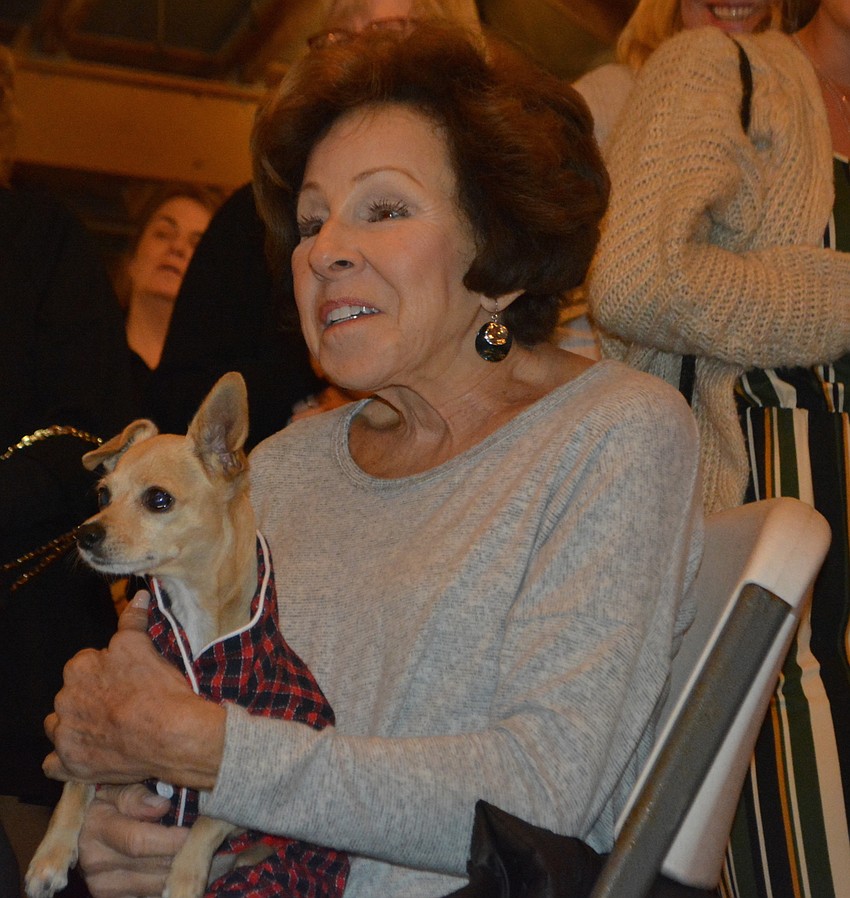 University Park's Anne Gold and her chihuahua terrier mix, Katy, watch the dogs on the red carpet.