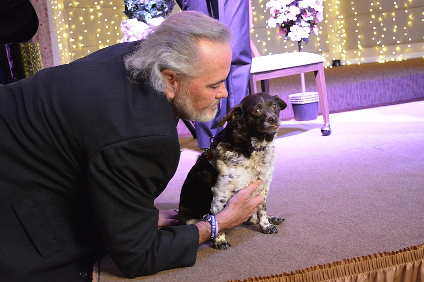 OASIS co-founder Randy Locke gives some special attention to Bunny, an adoptable dog being shown off.