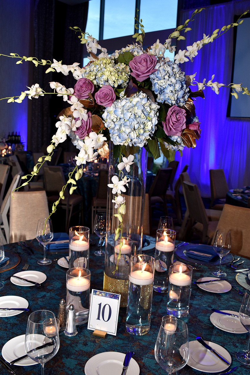 Multi-colored bouquets center each table.