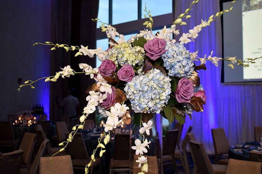 Multi-colored bouquets adorn each dinner table.