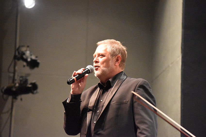 Maestro Joseph Caulkins welcomes the crowd.