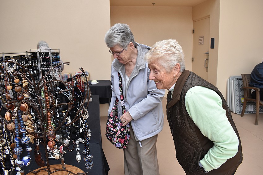 Grace Eidt and Eileen Christman look at some of the jewelry sold at the festival.