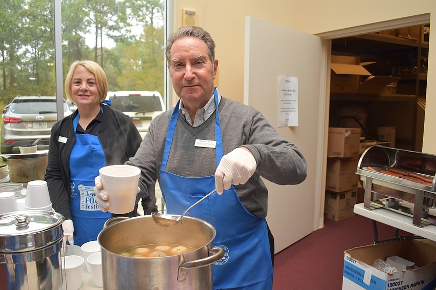 Kathy Stern and Doug Cohen serve matzo ball soup.