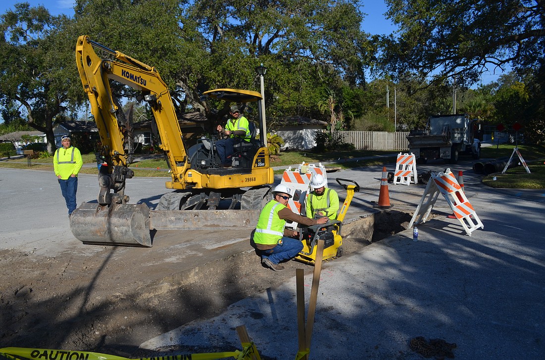 County stormwater staff works on a project along a Gulf Gate street Jan. 30. The county oversees the cityâ€™s stormwater system, but both governments are taking steps to address the topic, guided in part by resident input.