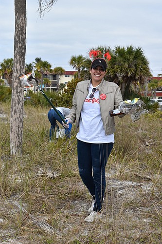 Sierra Taylor picks up trash on the beach for free Chick-Fil-A.