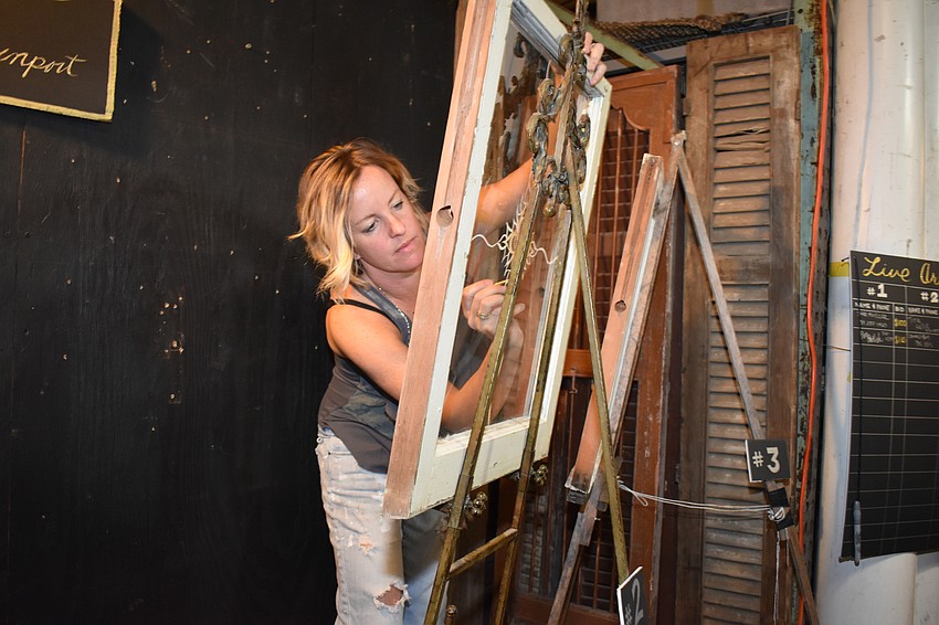 Maggie Davenport paints live art for An Evening for a Healthy Start.