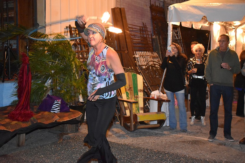 Heather Kirkendall spins fire on a hula hoop.