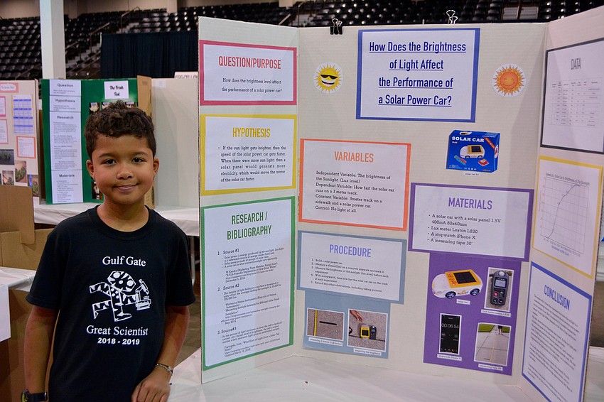 Takumi Fenderson, a fourth grader from Gulf Gate Elementary stands beside his project, 