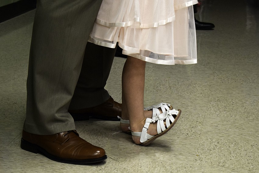 Ron Kennedy dances with his daughter, kindergartener Taylor, before she ran off to dance with some of the other kids.