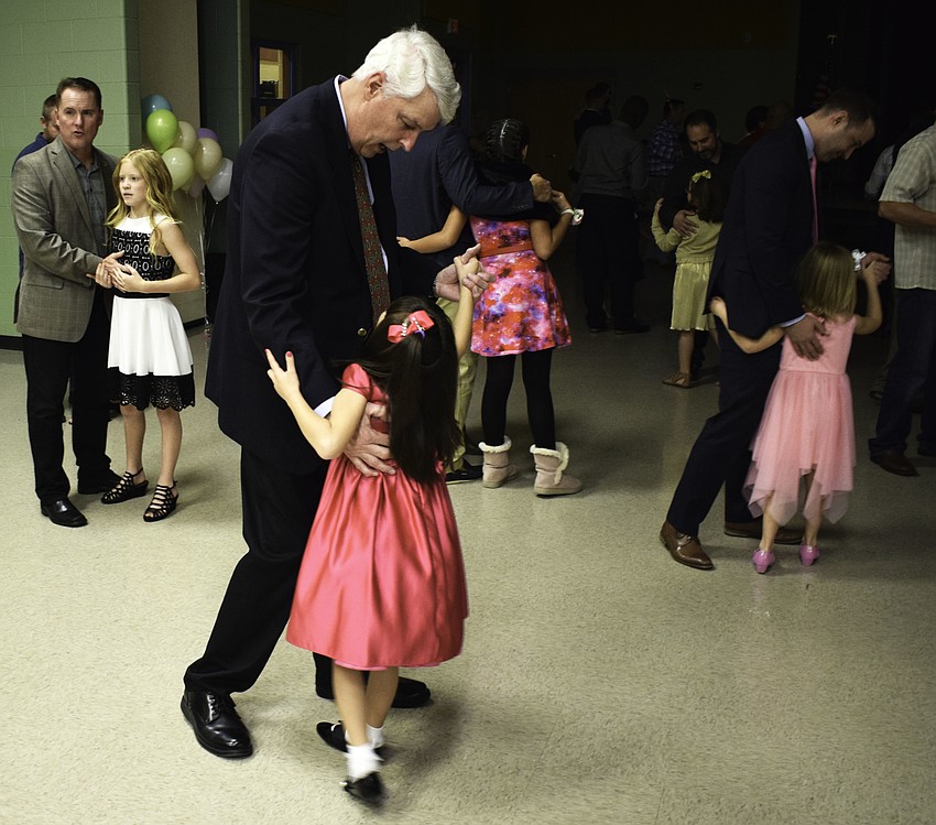 Mark Staddler dances with his daughter, second-grader Laura.