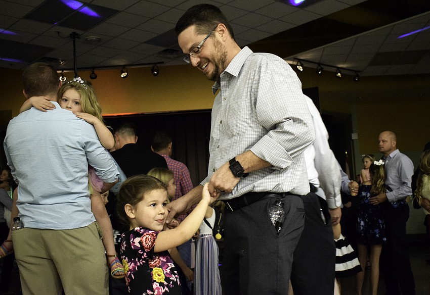 Dan LeClair dances with his preschooler daughter, 5-year-old Lydia, at McNeal Elementary's 
