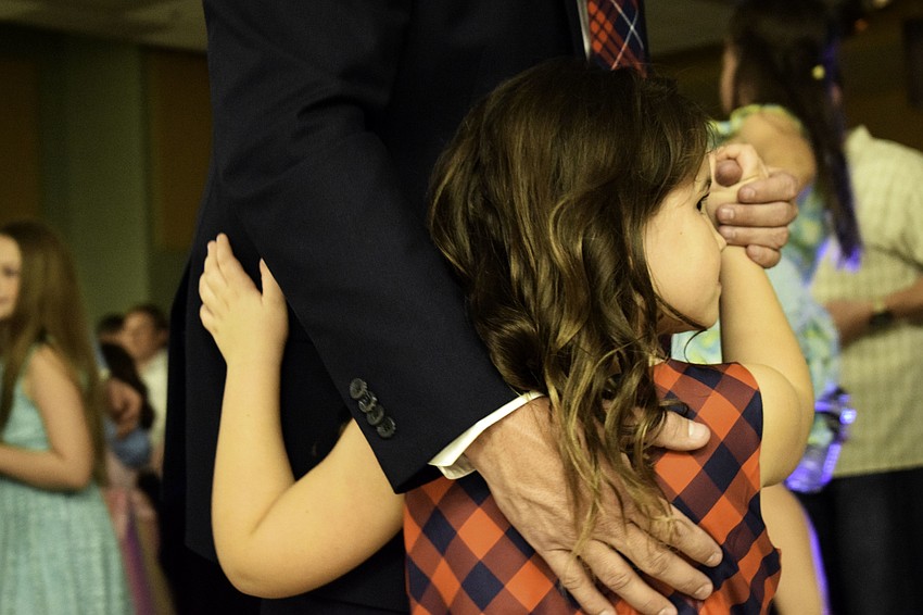 Reagan, a kindergartner, dances with her father, Josh Moffett, during a slower song.