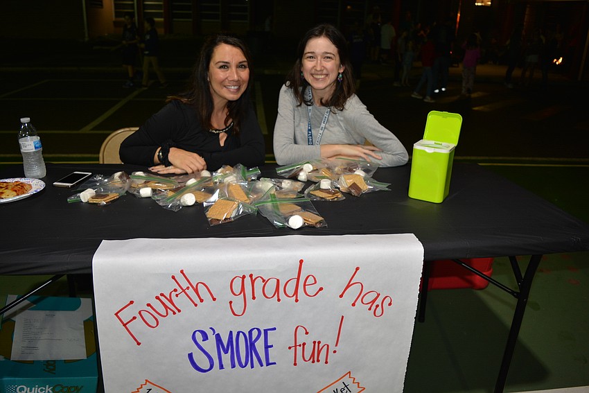 Volunteer Analia Mansi and fourth-grade teacher Caroline Shaw sell s'more packets, each equipped with a marshmallow, graham crackers and chocolate. Guests could roast their marshmallows over a fire pit.