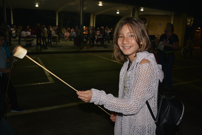 Fifth-grader Isabela Bennett said her favorite part of the bonfire event is hunting for friends, but that did not stop her from making a s'more.