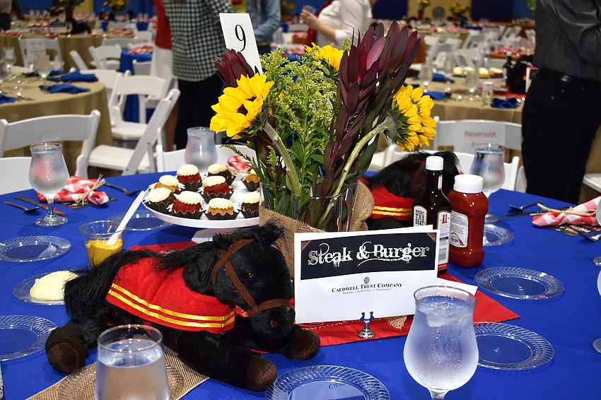 Tables were adorned with stuffed animal horses and sunflowers to go with the Western theme.
