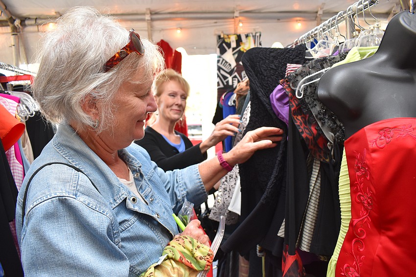 Pat Orre and Tricia Taormino take a look at some clothes for sale.
