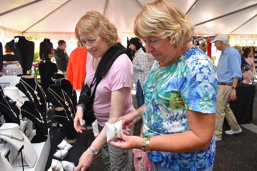 Joan Viele and Jane Vet examine some of the jewelry.