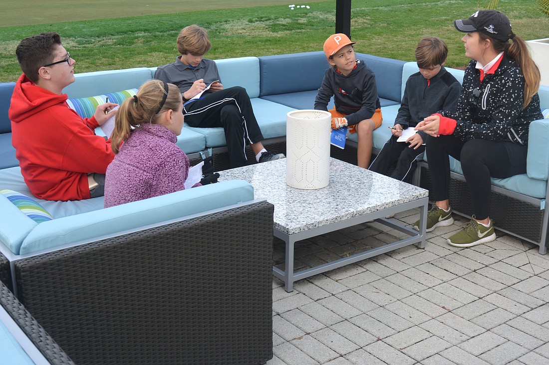 Katie McKenney, right, teaches her Birdies class before hitting the putting green.