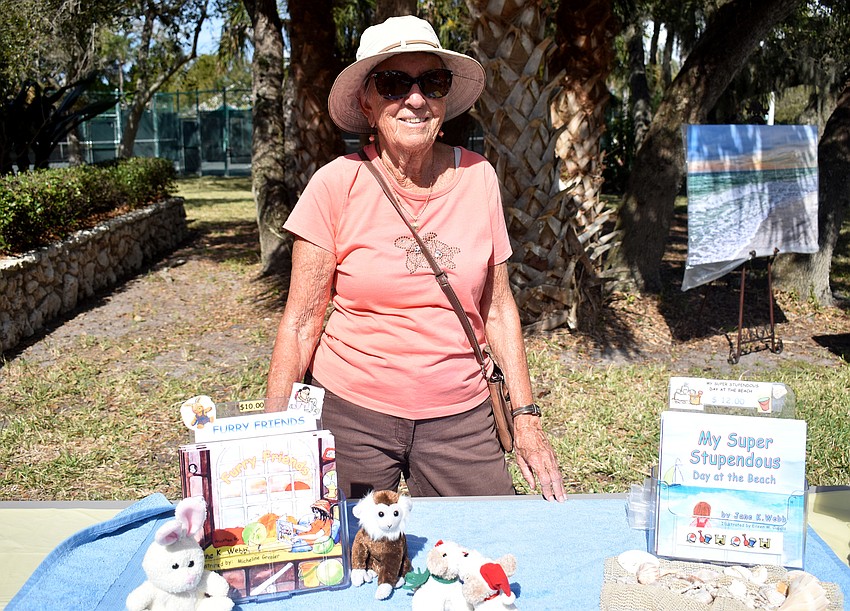 Jane Webb displays her children’s book during the festival.