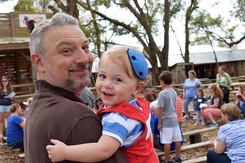 Michael Shefrin holds his son, Jacob Shefrin, following a round of song, prayer and dance with families at the 