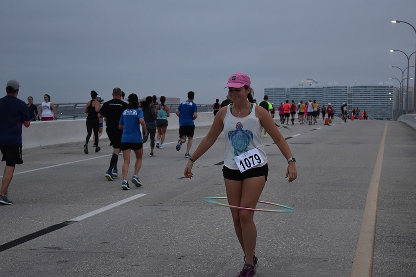 Antonia Ginsburg-Klemmt takes time out of the race to dance with a hula-hoop in front of every band.