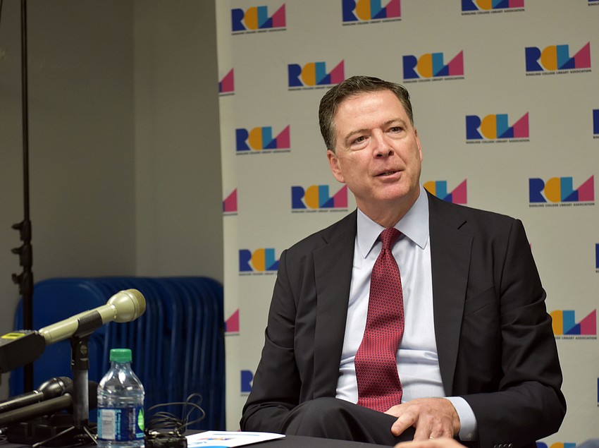 Former FBI Director James Comey fields questions from reporters before his lecture.