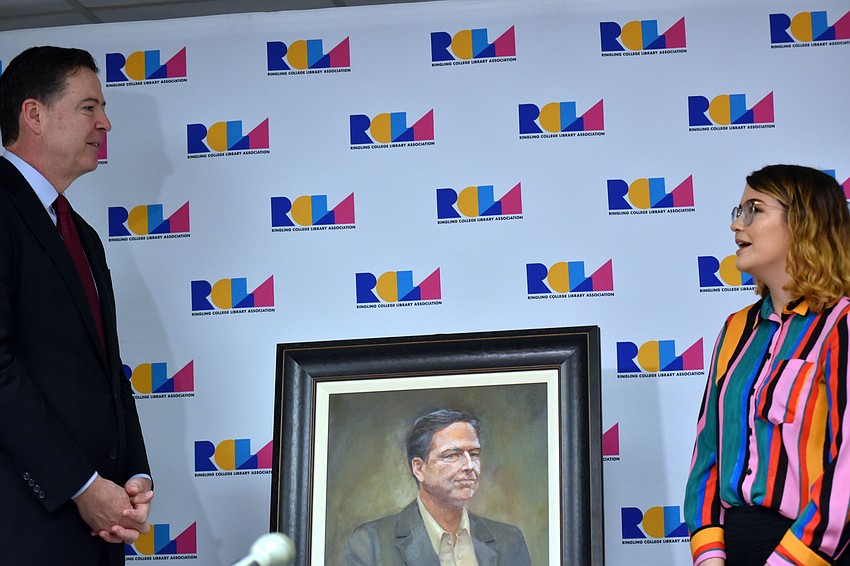James Comey gets his first look at the portrait Ringling College of Art and Design student Jensen Perehudoff painted of him.