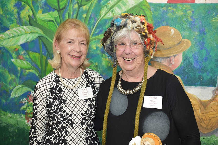 Judy O'Donnell with Carole Reiss, who is modeling a hat she made in needlepoint.