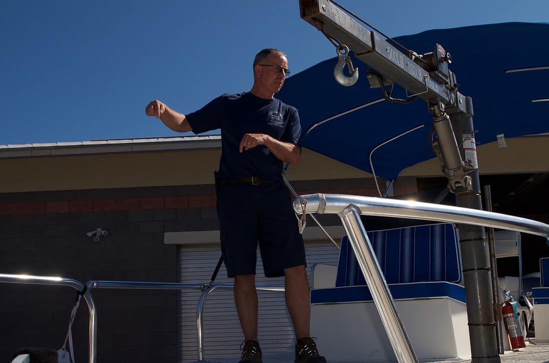 Mark Kerr of Public Works explains how department&#39;s boat is used.