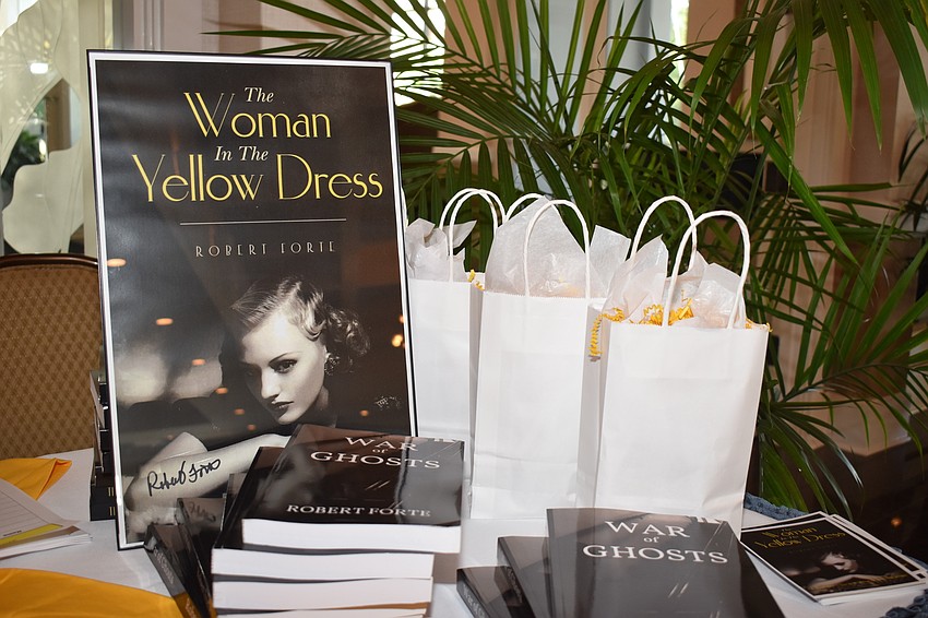 A signed poster with the author's other book were for sale at the luncheon.