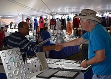 Joseph Khalipha, of the business Secrets of the Desert, shakes hands with patron Frank Callan, of Atlanta.