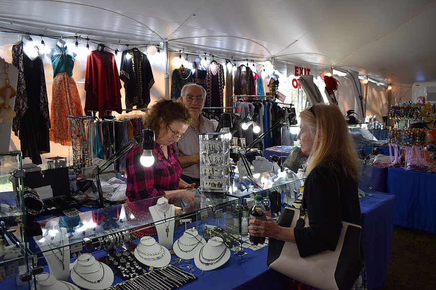 Mary Duvlaris, along with her friend, Nick Klonaris, makes a sale to Diane Agle of Virginia.