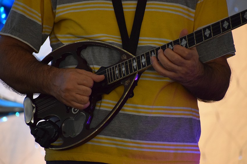 Leonidas Zaferis, a musician in the band Ellada, plays the bouzouki.