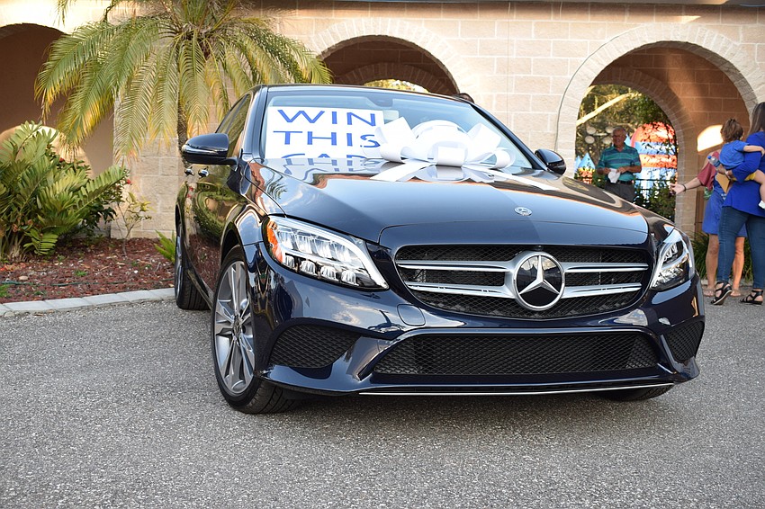 As part of the festival, attendees can participate in a raffle. The grand prize is a new car worth $30,000.