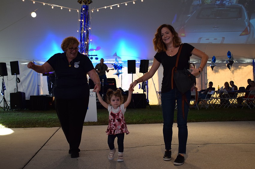 St. Barbara parishioner Popi Ameres dances with her granddaughter, Sofia, and daughter in law, Kali Ameres.